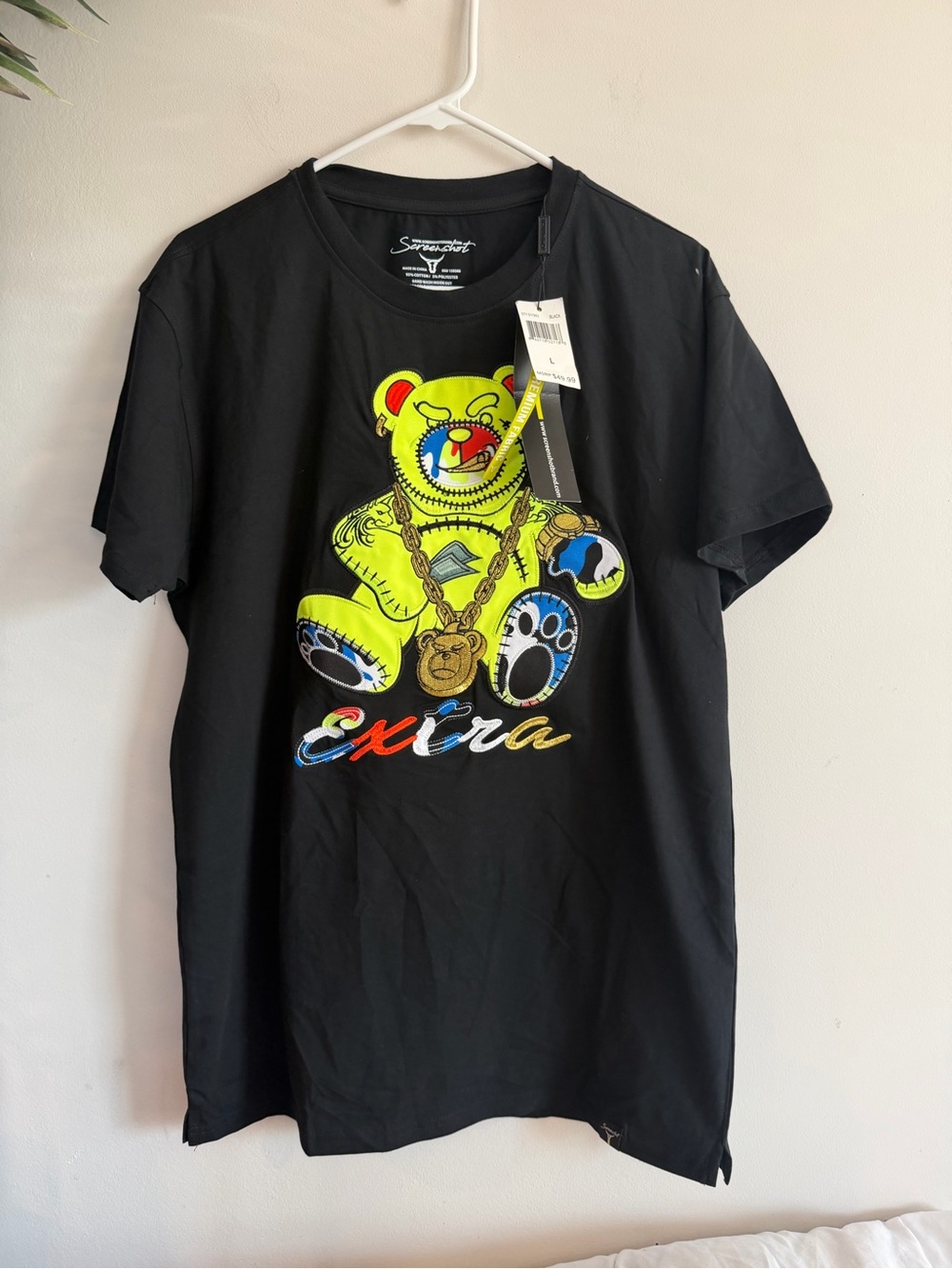 Screenshotbrand hip-hop fashion tee features a prominent neon yellow cartoon